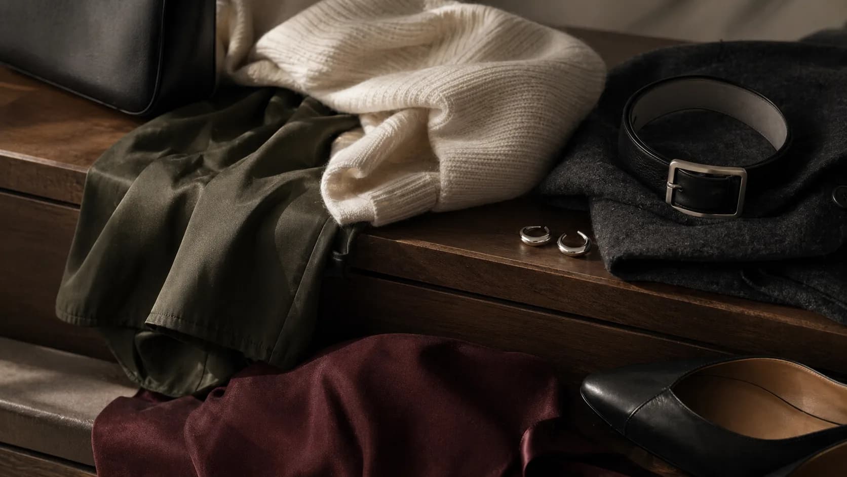 Modern Korean fashion materials with knitwear, leather, wool, and dark accessories